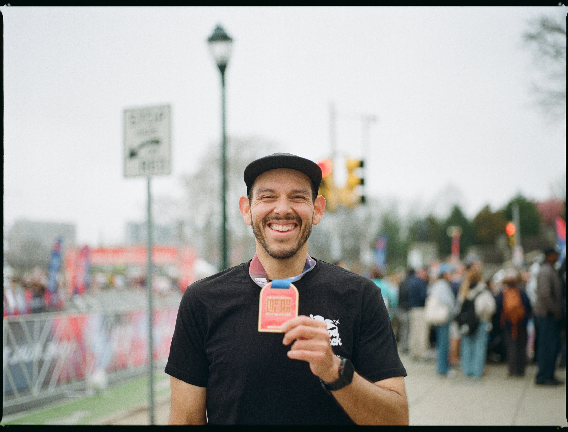 Marco Moreno holding his race medal