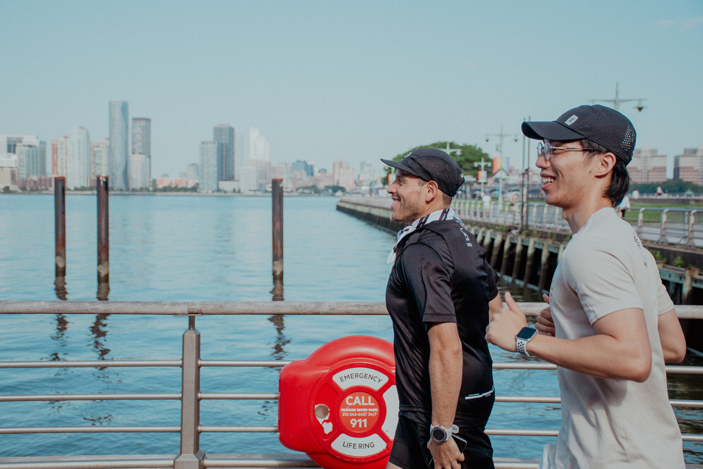 Marco leading a runner along the New York City waterfront